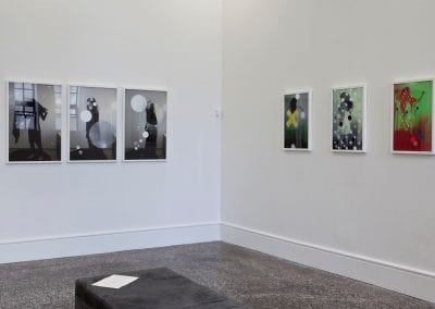 Gallery interior with six digital collages on white walls