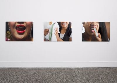 Three photographs on wall, each a different closeup of peoples' grills