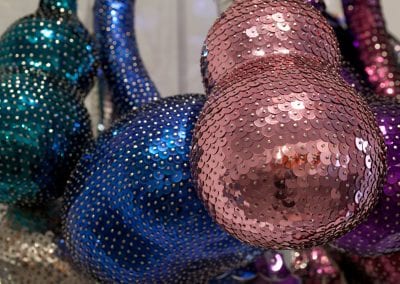 Close up of colourful sequinned gourd shaped forms