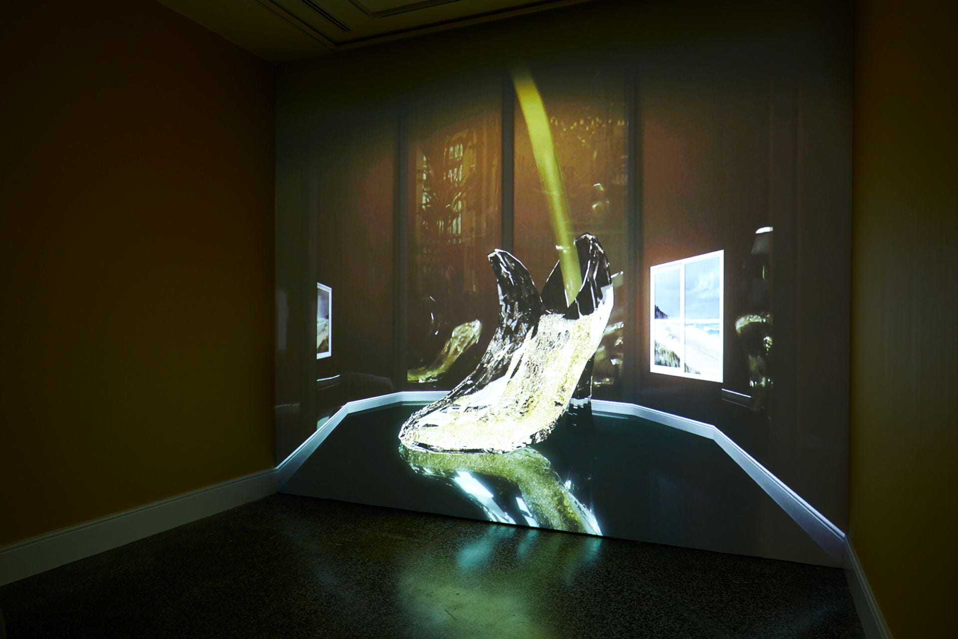 A projected film depicting a 3D computer generated model of a glass slipper being filled with champagne.