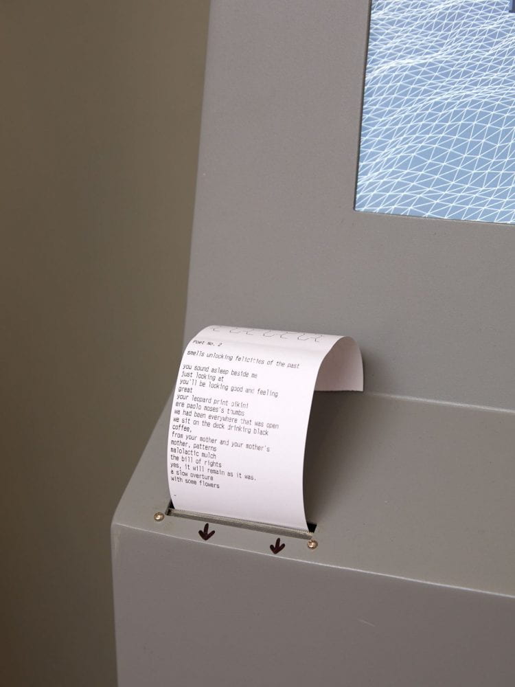 A close-up of a steel grey ATM machine, with a receipt being printed out of it. The receipt has lines of a poem written on it.