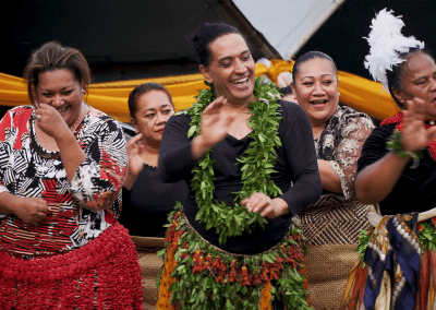 Women perform a dance, dressed in traditional Tongan attire.