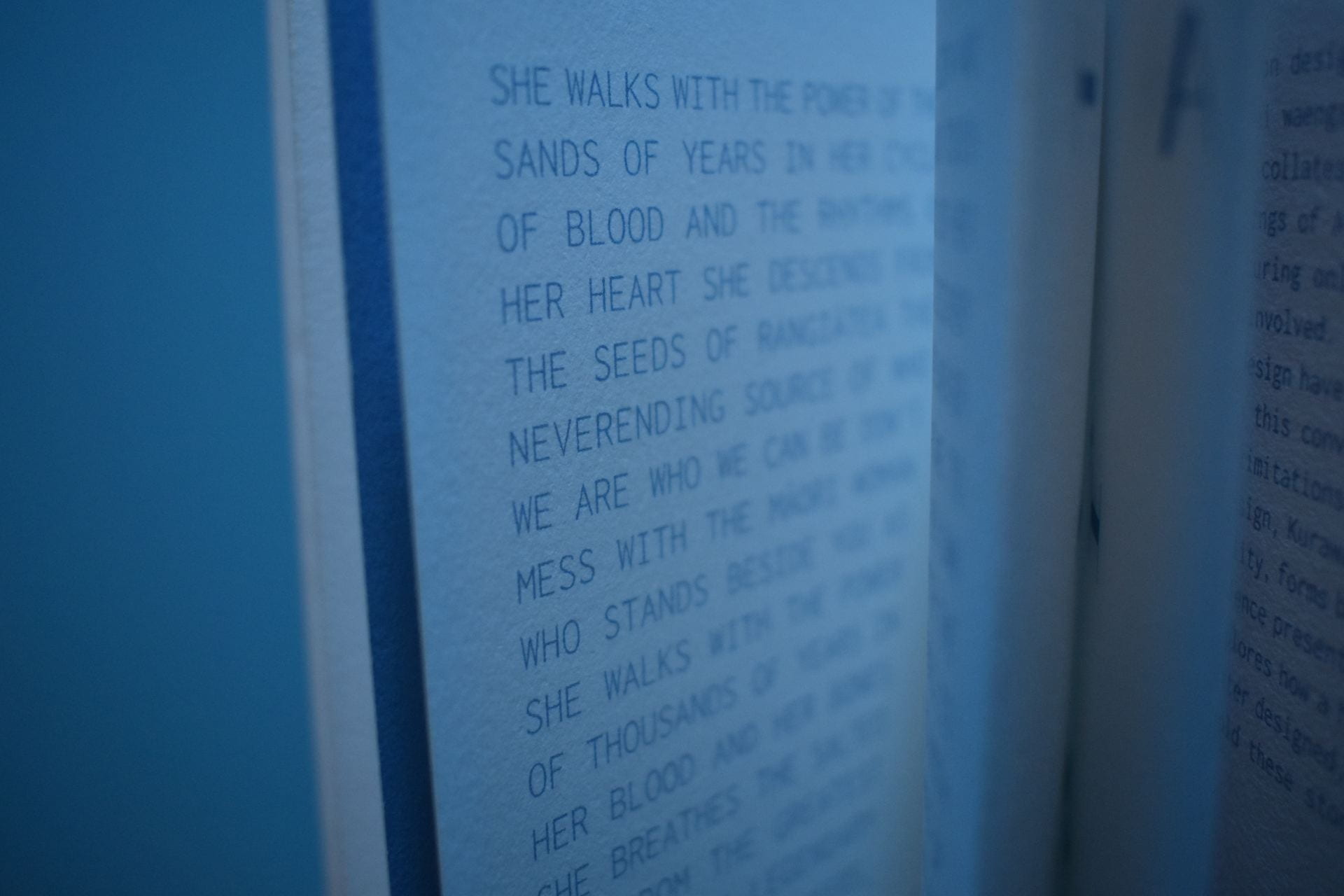 Close-up of text inside a spiral-bound book.